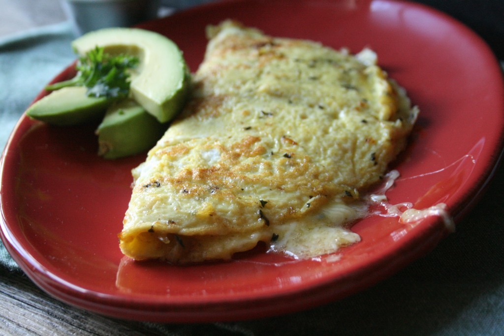 Simple ham & cheese omelet  cooked in basil butter