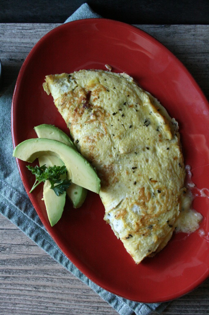 A Simple & Delicious Ham & Cheese Omelet cooked in Homemade Basil Butter