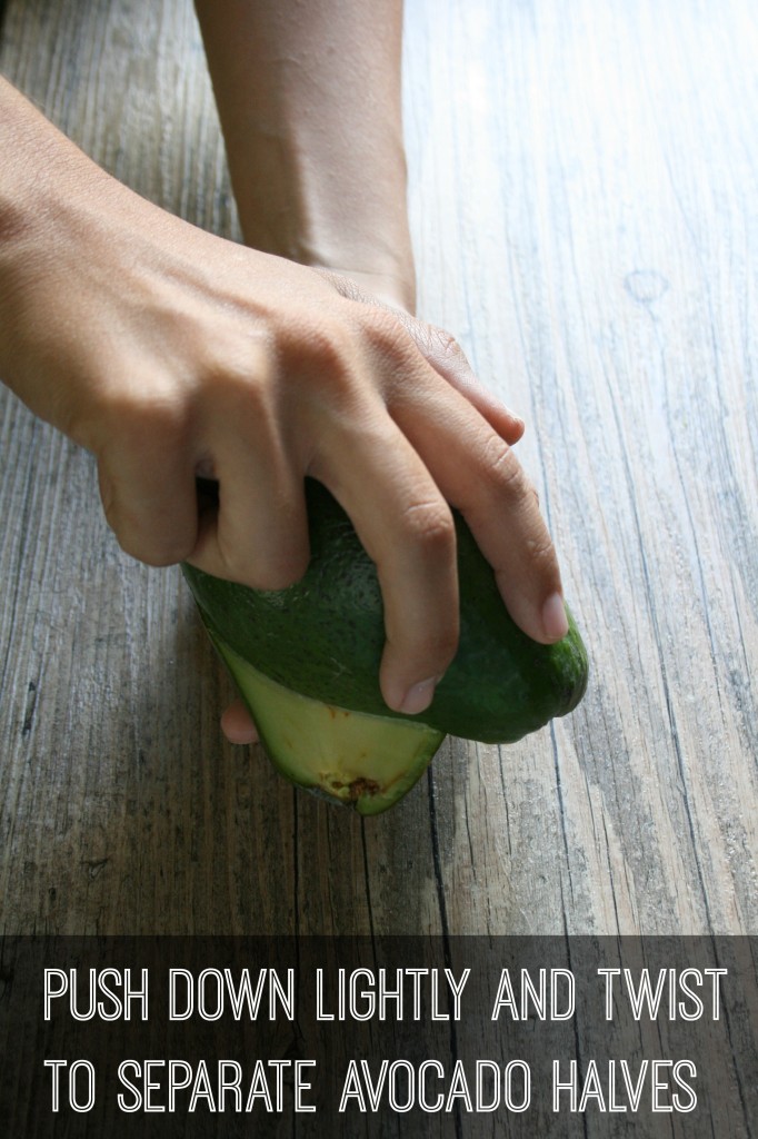 push down lightly to separate avocado halves